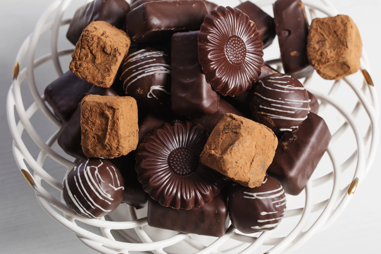 Assorted chocolate treats on a wooden counter in a modern kitchen.