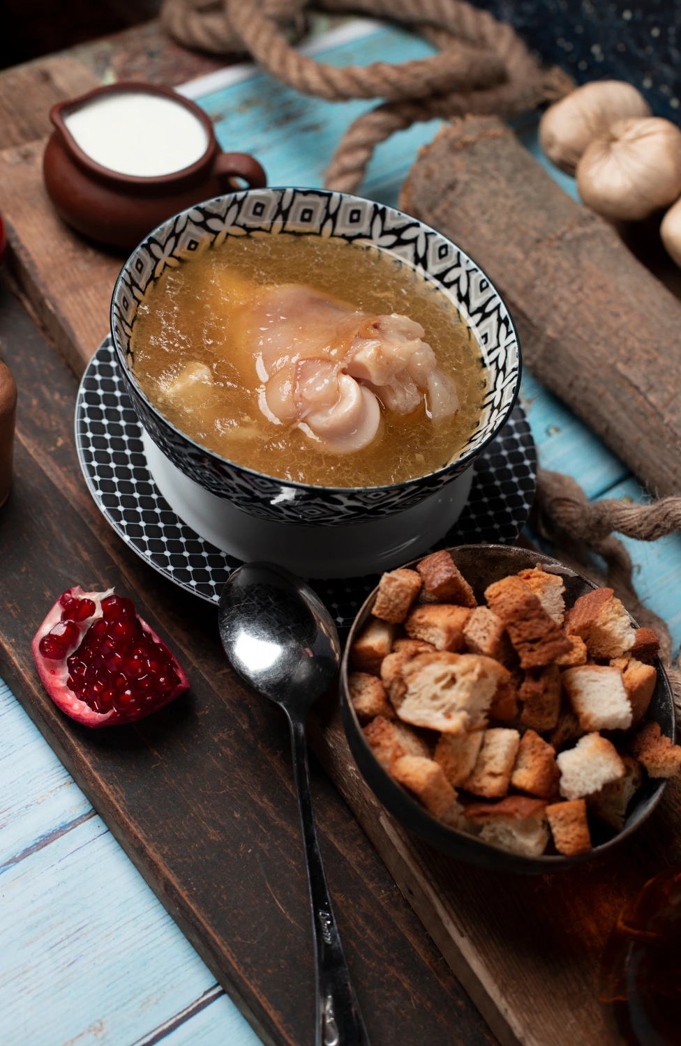 A simmering pot filled with soup bones, vegetables, and aromatic herbs, creating a rich and flavorful broth.