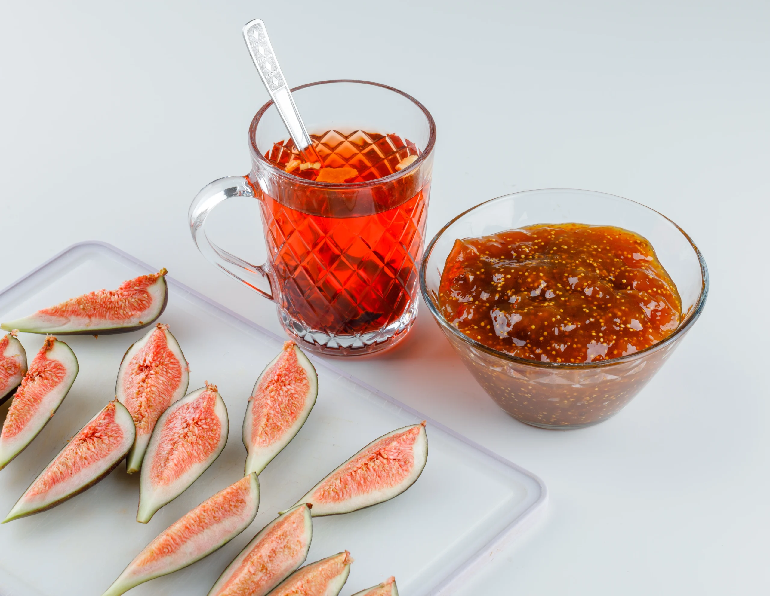 A glossy block of guava paste served with cheese and crackers, illustrating its versatility as a dessert or appetizer.