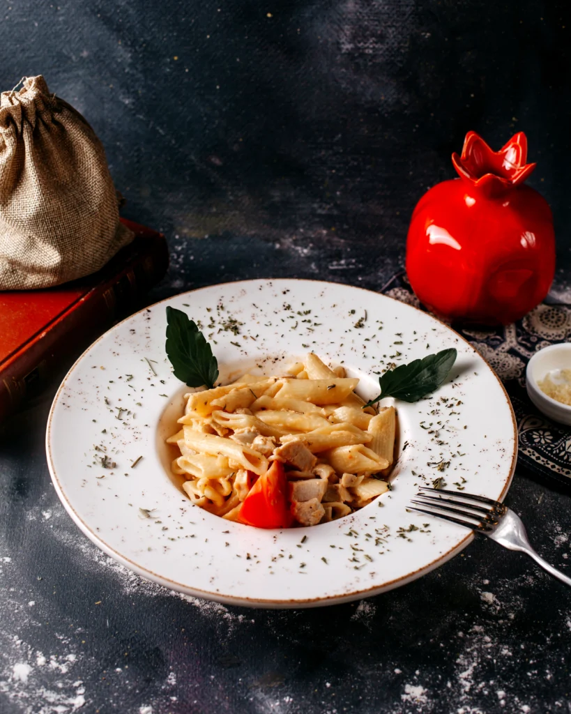 Fettuccine bolognese served with red wine and crusty bread in an Italian-style setting.